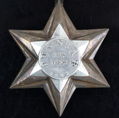 Lot 3033 - A Gwalior Star in bronze, the central silver...