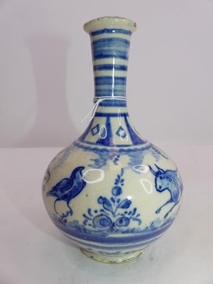 Lot 2361 - A Persian blue and white glazed bottle vase,...