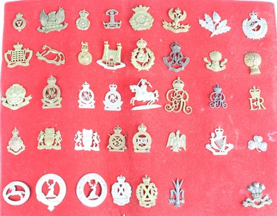 Lot 3083 - A collection of cap badges and insignia to...