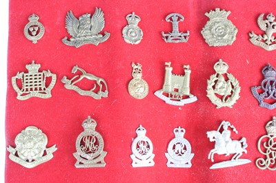 Lot 3083 - A collection of cap badges and insignia to...