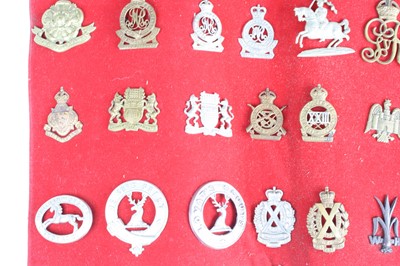 Lot 3083 - A collection of cap badges and insignia to...