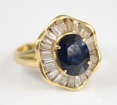 Lot 2224 - A yellow metal, sapphire and diamond oval...