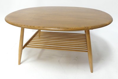 Lot 395 - An Ercol blond elm 'Model 454' oval coffee...