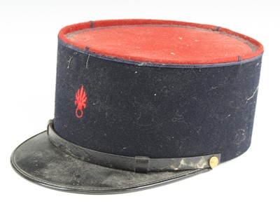 Lot 3261 - A French Foreign Legion kepi, in blue felt...