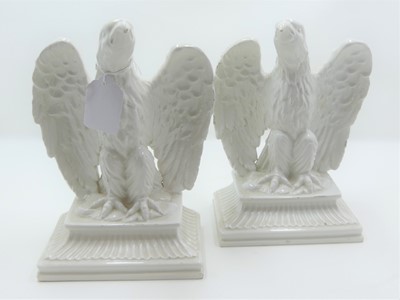 Lot 10 - A pair of white glazed pottery models of...