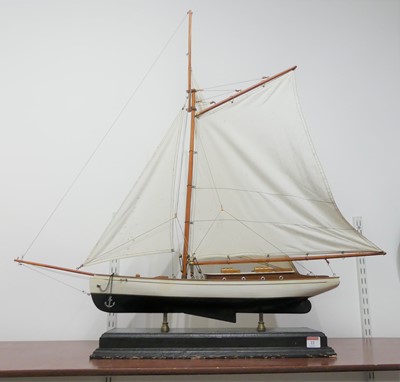 Lot 22 - A wooden model of a yacht, mounted on a wooden...