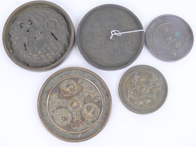Lot 54 - A collection of five Chinese metal mirrors,...