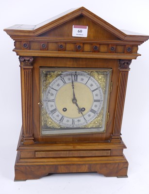 Lot 60 - An early 20th century walnut mantel clock, the...