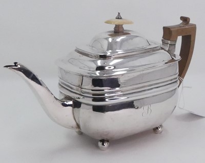 Lot 219 - A George III silver teapot, having carved wood...