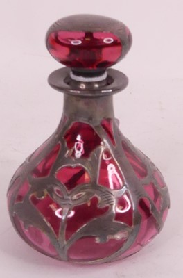 Lot 169 - An Art Nouveau white metal overlaid cranberry...