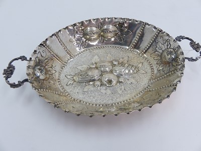 Lot 240 - A white metal dish, repousse decorated with...