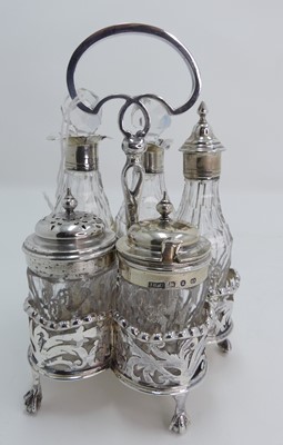 Lot 241 - A late Victorian silver and glass table cruet...