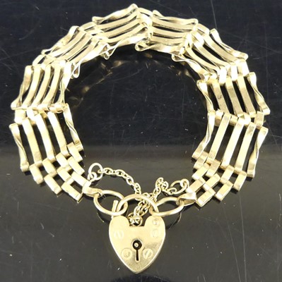 Lot 258 - A 9ct gold gatelink bracelet with heart shaped...