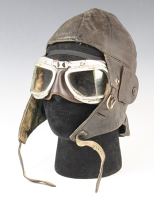 Lot 3381 - A brown leather flying type helmet, having a...