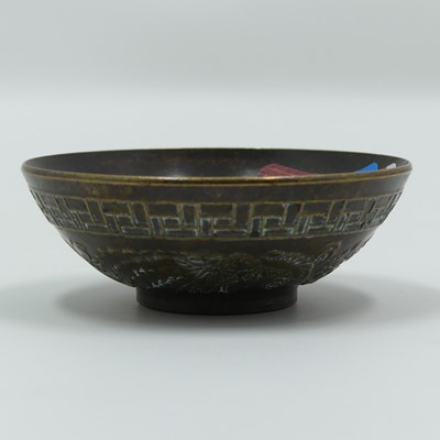 Lot 334 - A Chinese bronzed metal bowl, relief decorated...