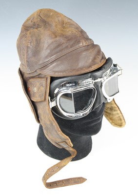 Lot 3384 - A brown leather flying type helmet, together...