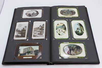 Lot 419 - An early 20th century postcard album, having a...