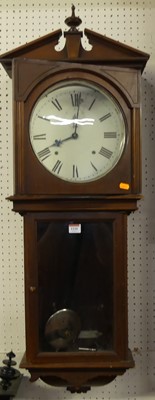 Lot 1110 - A walnut drop trunk wall clock, with pendulum...