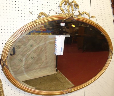 Lot 1112 - A circa 1900 reeded gilt framed bevelled oval...