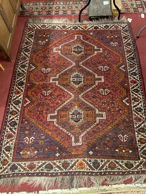 Lot 1117 - A Persian woollen red ground Quashqai rug, 200...