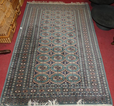 Lot 1120 - A Persian woollen sage ground Bokhara rug,...