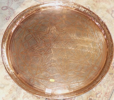 Lot 1180 - An Eastern floral engraved copper circular...