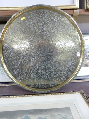 Lot 1147 - An Eastern floral engraved brass circular tray,...