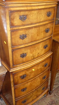 Lot 1210 - A reproduction walnut bowfront narrow tallboy,...