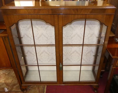 Lot 1213 - A 1930s walnut double door glazed china...