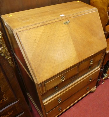 Lot 1154 - A mid 20th century light oak slope front...