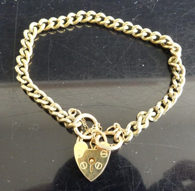 Lot 282 - A 9ct gold curblink bracelet with heart shaped...