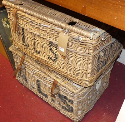 Lot 1062 - A wicker hamper with leather strap and black...