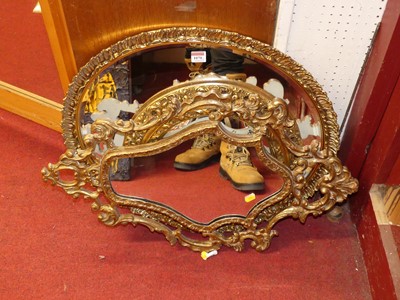 Lot 1070 - A reproduction gilt framed and bevelled oval...