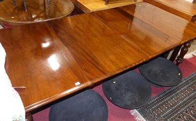 Lot 1232 - A mahogany round cornered extending dining...