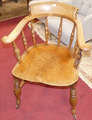 Lot 1253 - A circa 1900 elm tub captains's chair, width 67cm