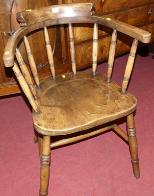 Lot 1271 - An early 20th century elm tub captain's chair,...