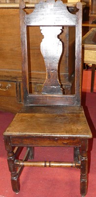 Lot 1280 - An antique joined oak panelled seat splat back...