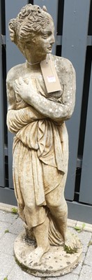 Lot 1313 - A reconstituted stone garden statue of a...