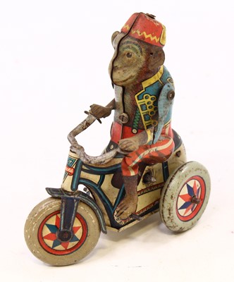 Lot 2049 - An Arnold tin plate and clock work monkey on...