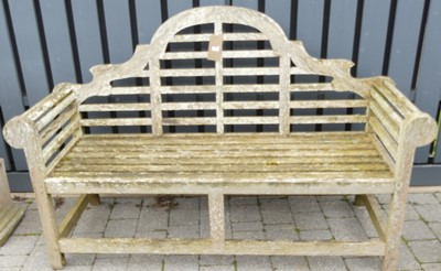 Lot 1319 - A teak slatted three-seater Lutyens bench,...