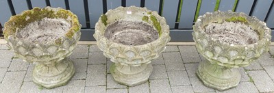 Lot 1321 - A set of three reconstituted stone pedestal...