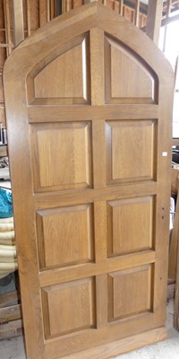 Lot 47 - An external oak eight-panel door, with arched...