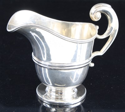 Lot 321 - An Edwardian silver cream jug, of helmet shape...