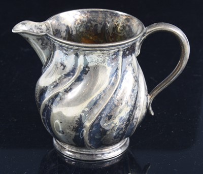 Lot 274 - A William IV silver cream jug, of wrythen form...