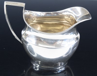 Lot 267 - A George V silver milk jug, of helmet shape,...