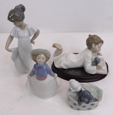 Lot 129 - A collection of four Nao porcelain figures,...