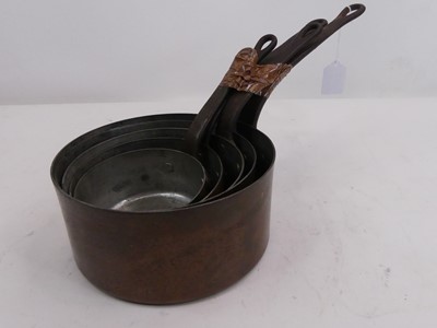 Lot 156 - A graduated set of five copper saucepans