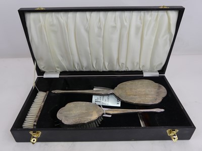 Lot 285 - A silver clad four-piece dressing table set,...