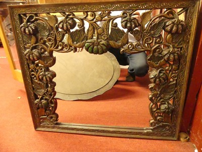 Lot 1104 - A faux walnut framed and bevelled oval wall...