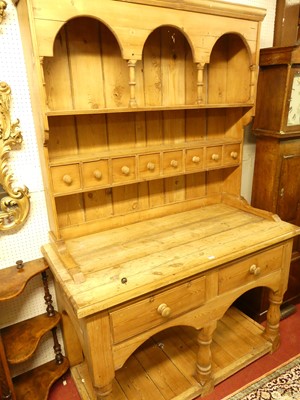 Lot 1146 - A rustic pine kitchen dresser, having two...